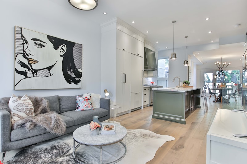 Open-plan living and dining space with kitchen island and timber floors